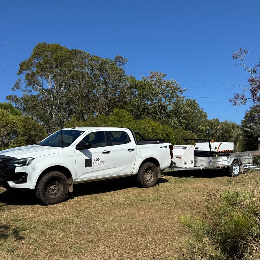 The ADS Forestry ute and plant trailer parked on a mown block